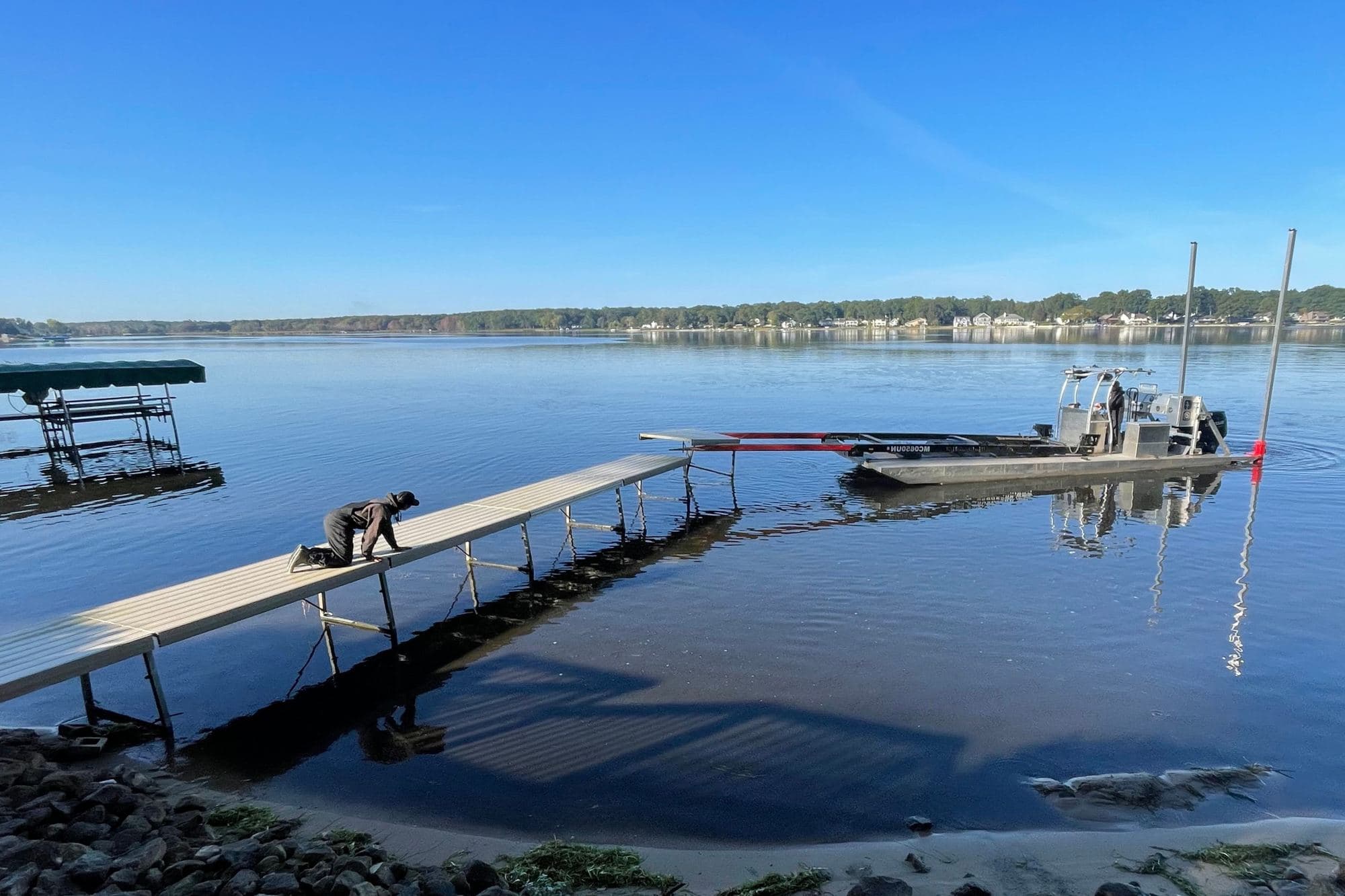 Fresh Coast crew installing a dock section from a work barge