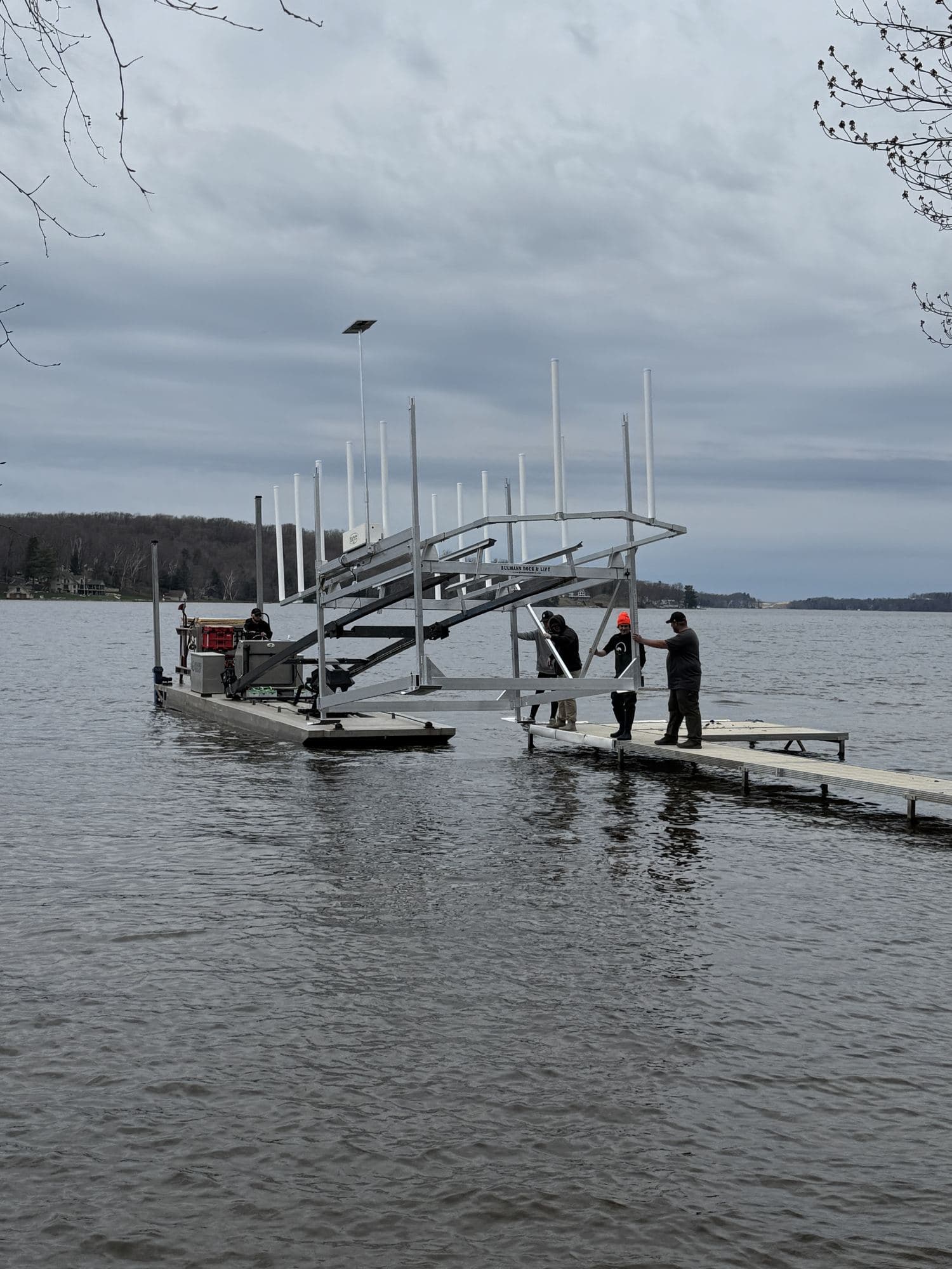 Boat lift being set in the water by the Fresh Coast crew